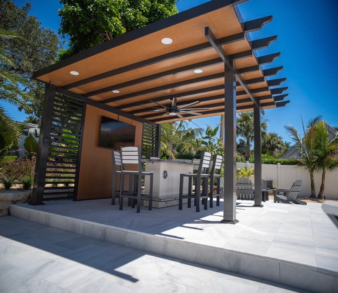 Pergola with outdoor kitchen on a travertine patio