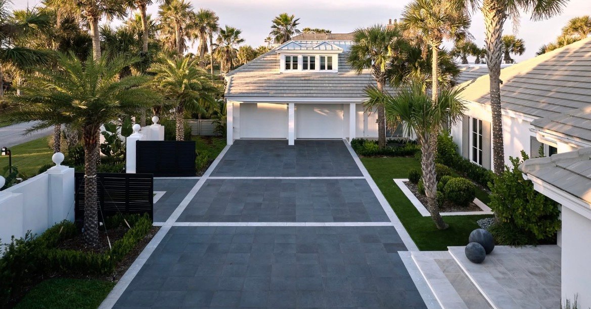 Dark modern paver driveway with contrasting white borders