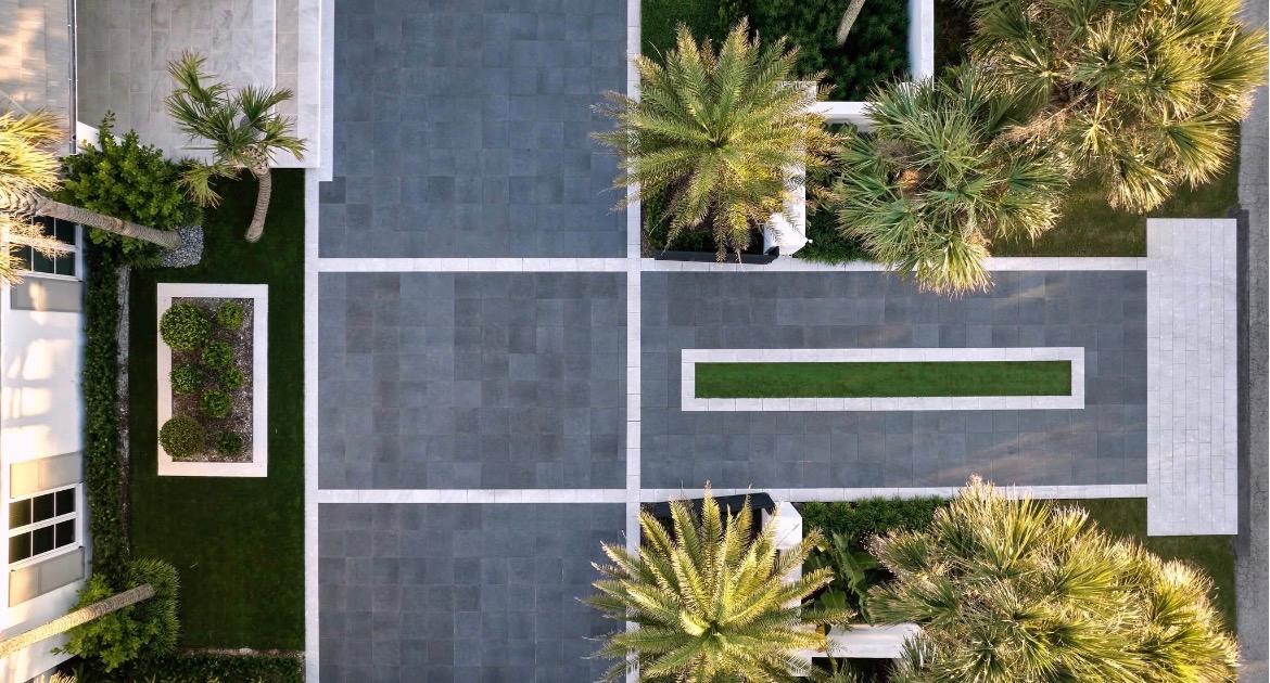 Aerial view of a well-maintained Treasure Coast residential estate with manicured plantings and paver drive