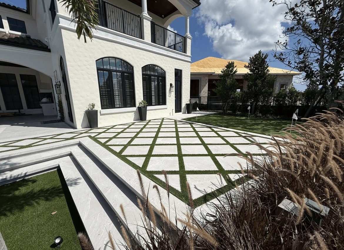 Paver and artificial-turf checkerboard patio with putting green