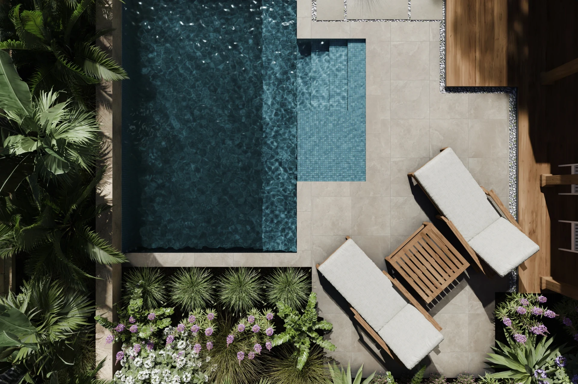 Aerial top-down view of a pool with lounge chairs, a wood side table, and lush tropical planting